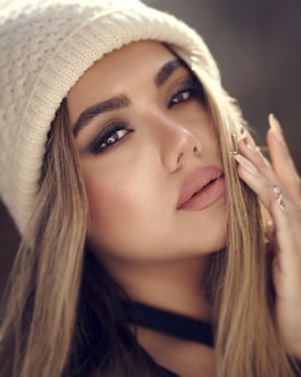 a woman with long hair wearing a white hat