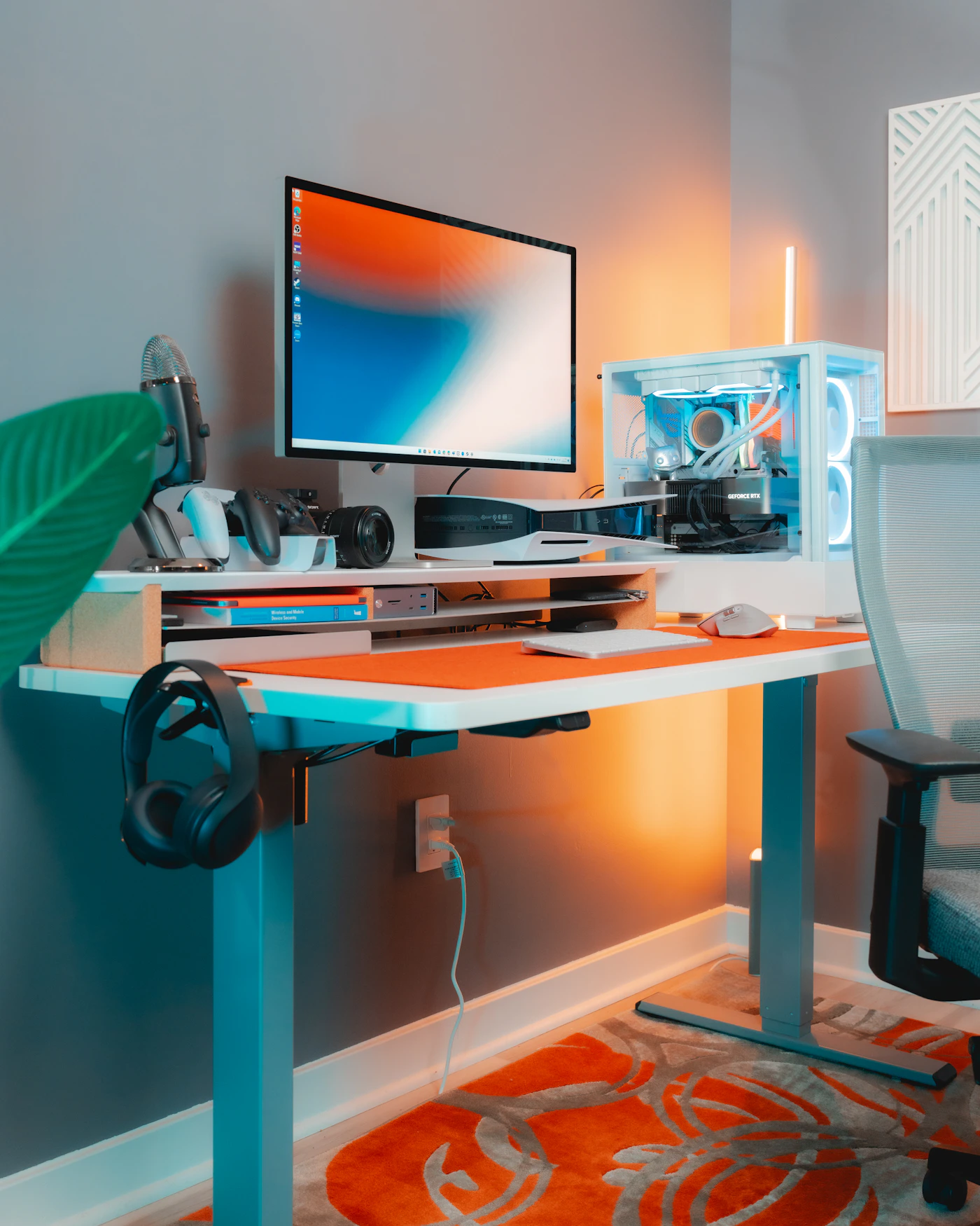 Modern gaming desk with monitor, computer, controller, keyboard, mouse, and headset