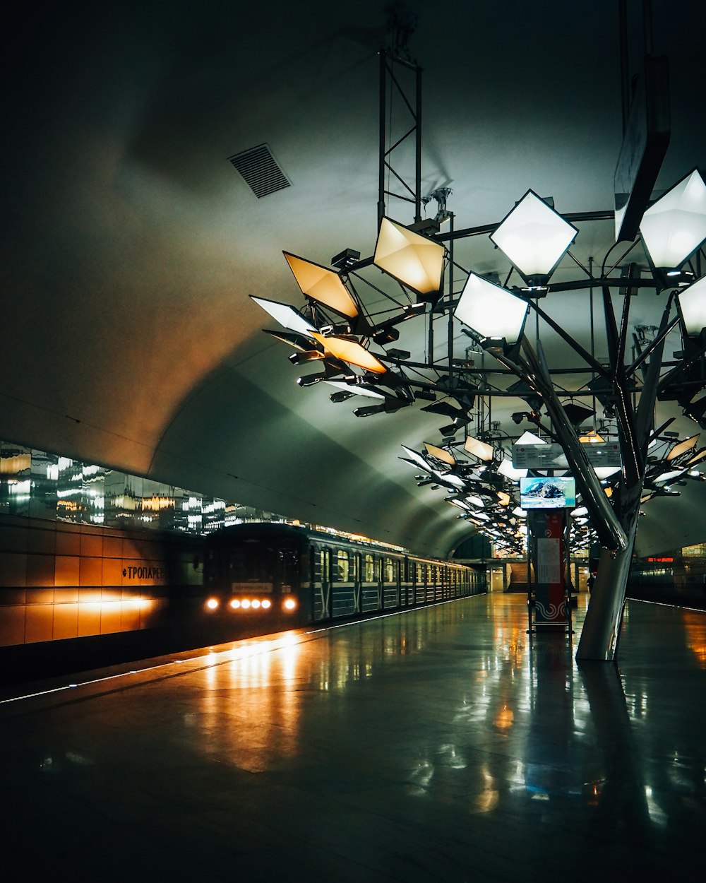 a train pulling into a train station at night