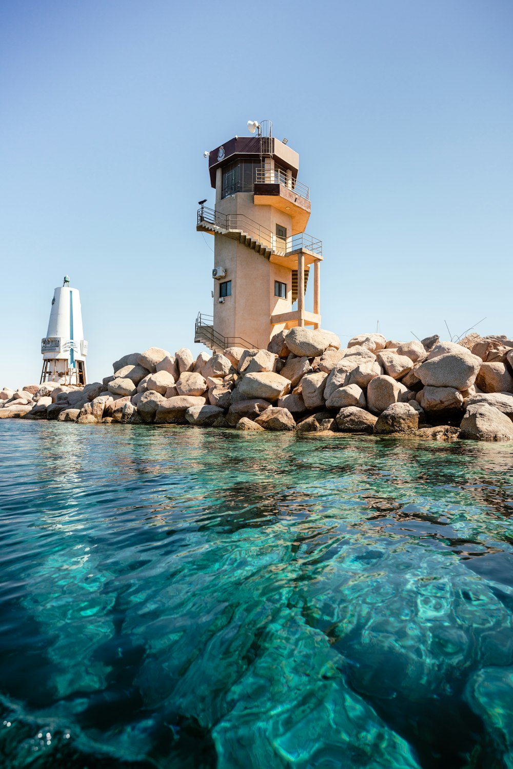 a light house sitting on top of a rocky shore