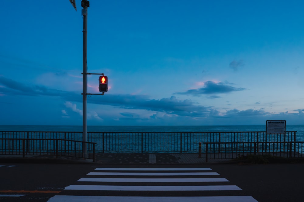 a red traffic light sitting on the side of a road