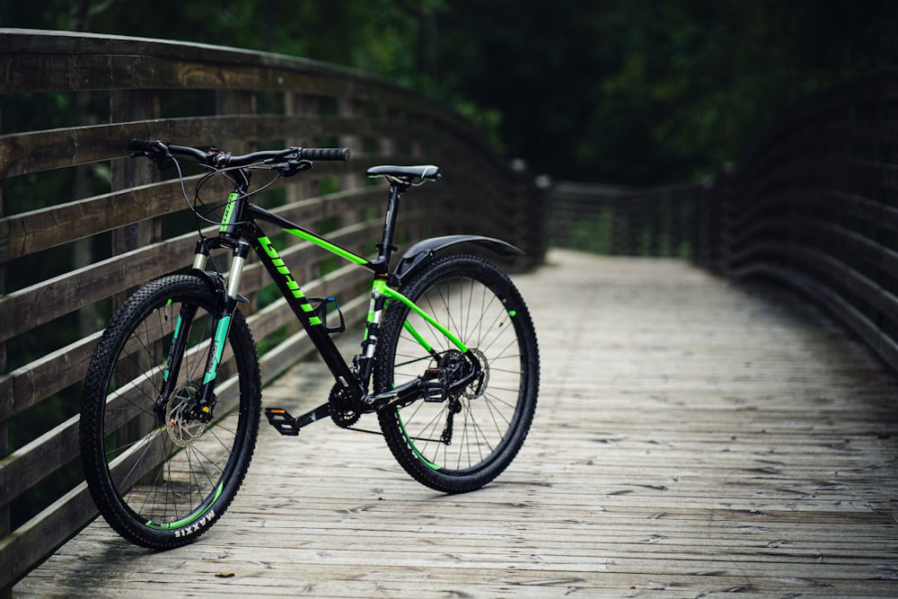 a bike is parked on a wooden bridge