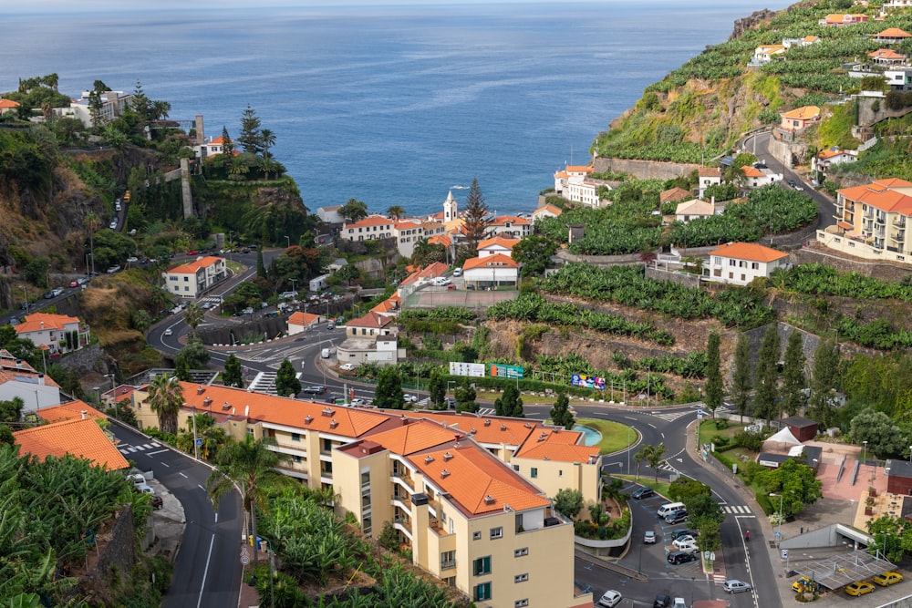 an aerial view of a town with a mountain in the background