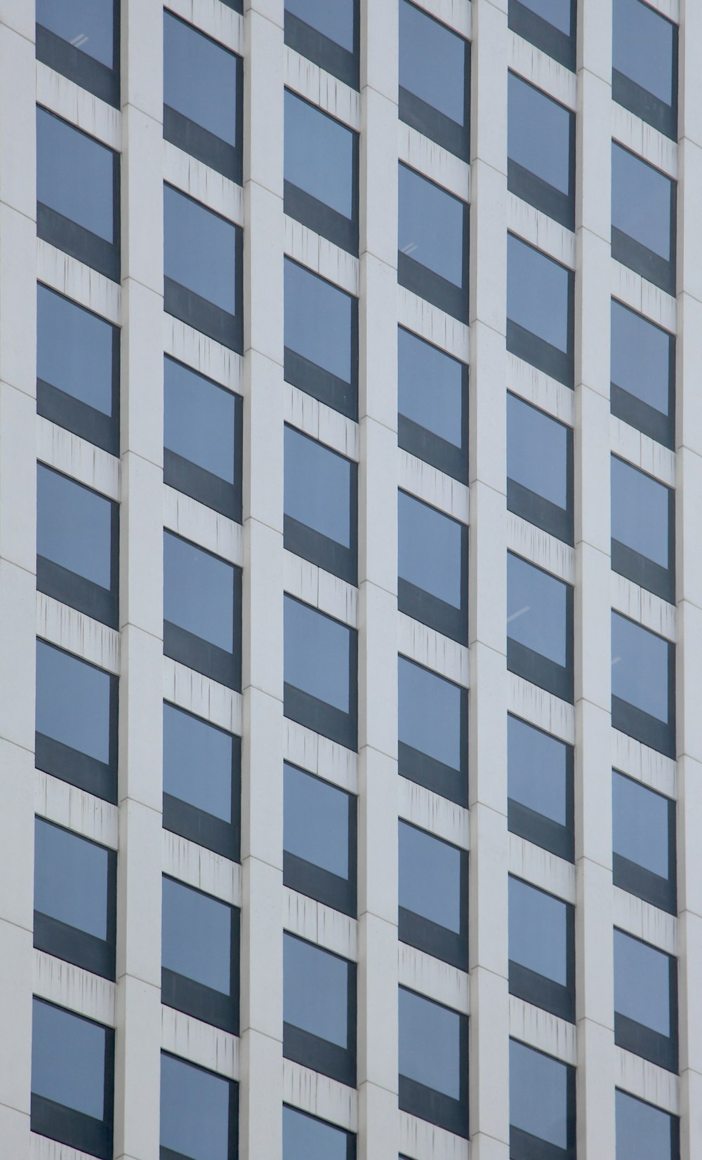 an airplane flying in front of a tall building