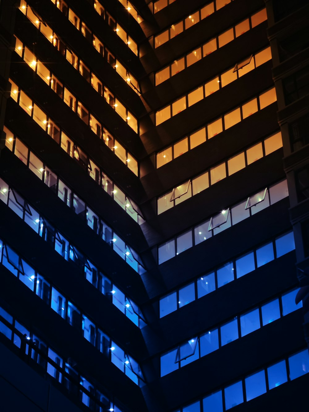 a tall building with many windows lit up at night