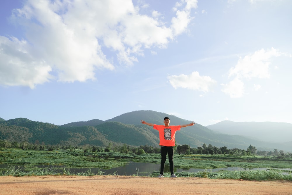 a man standing on top of a dirt field