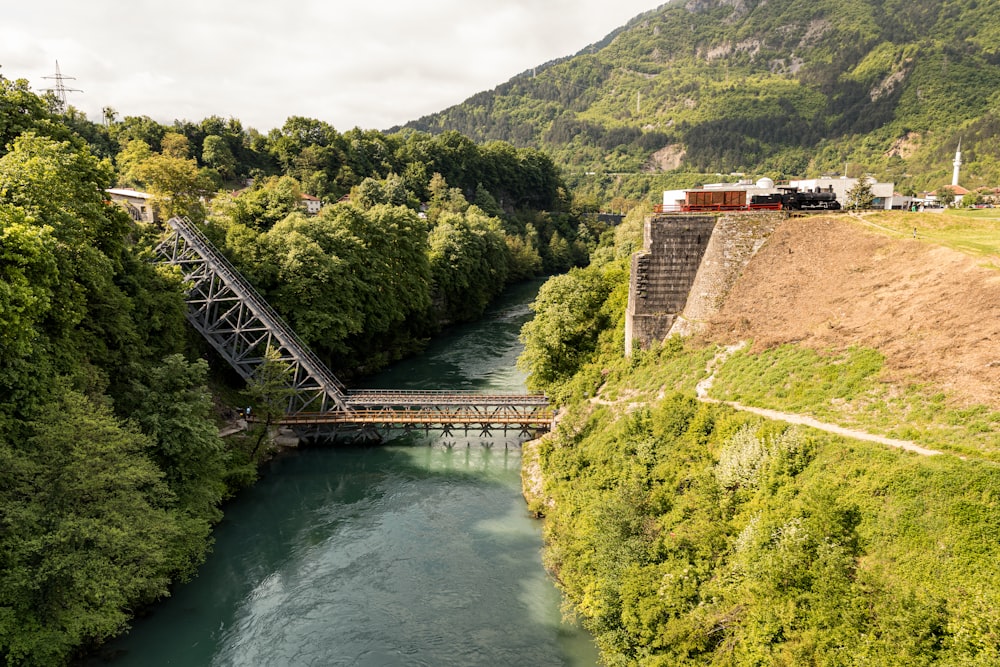 a train traveling over a bridge over a river