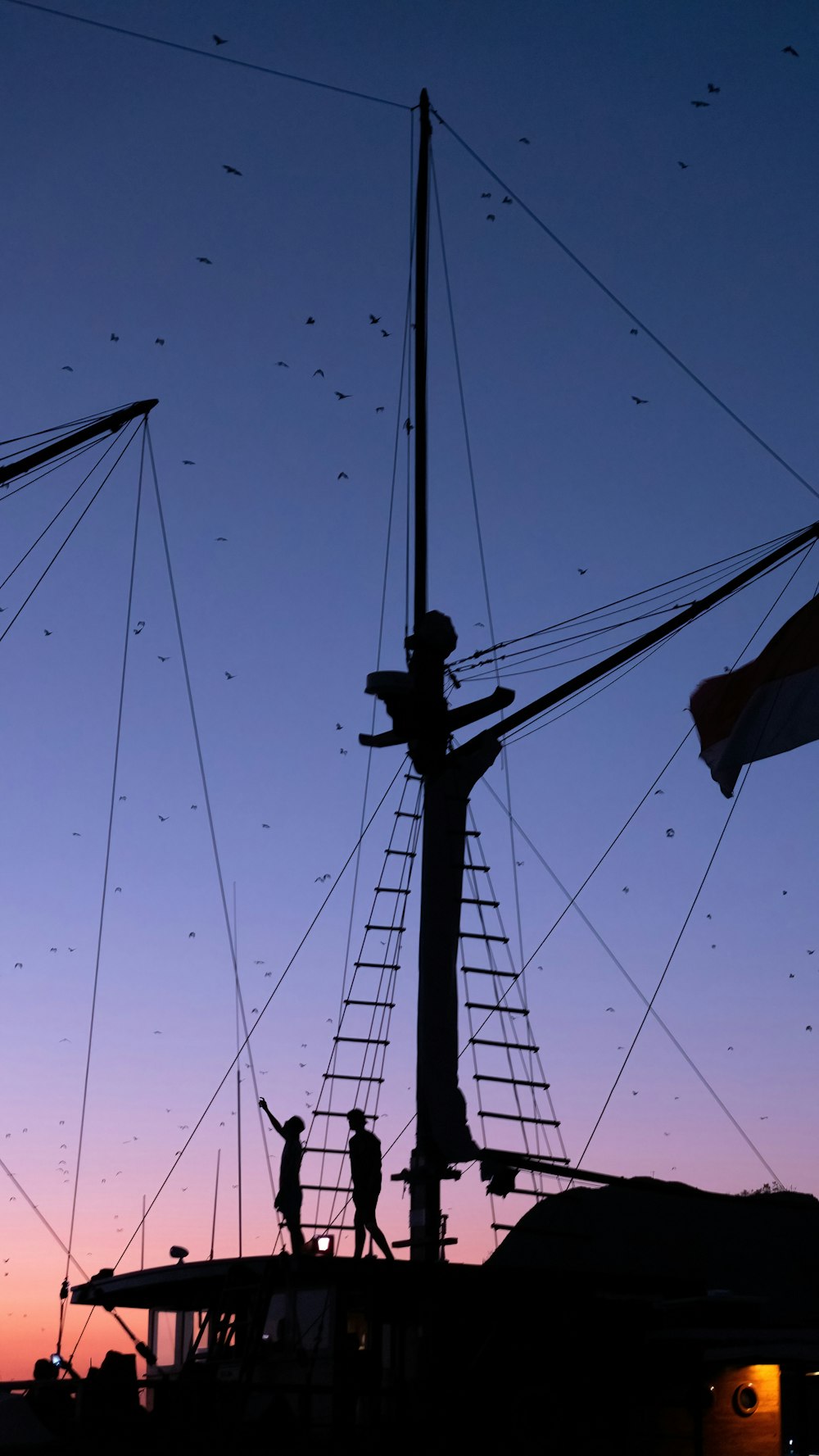 a group of people standing on top of a boat