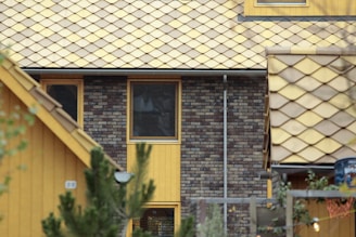 a yellow building with a clock on the front of it