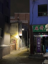 Street view showing the entrance of Gangnam Someday 0.5 at night.