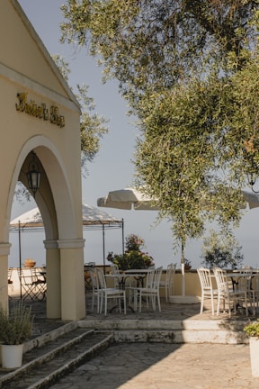 A spacious outdoor patio with comfortable seating and greenery.