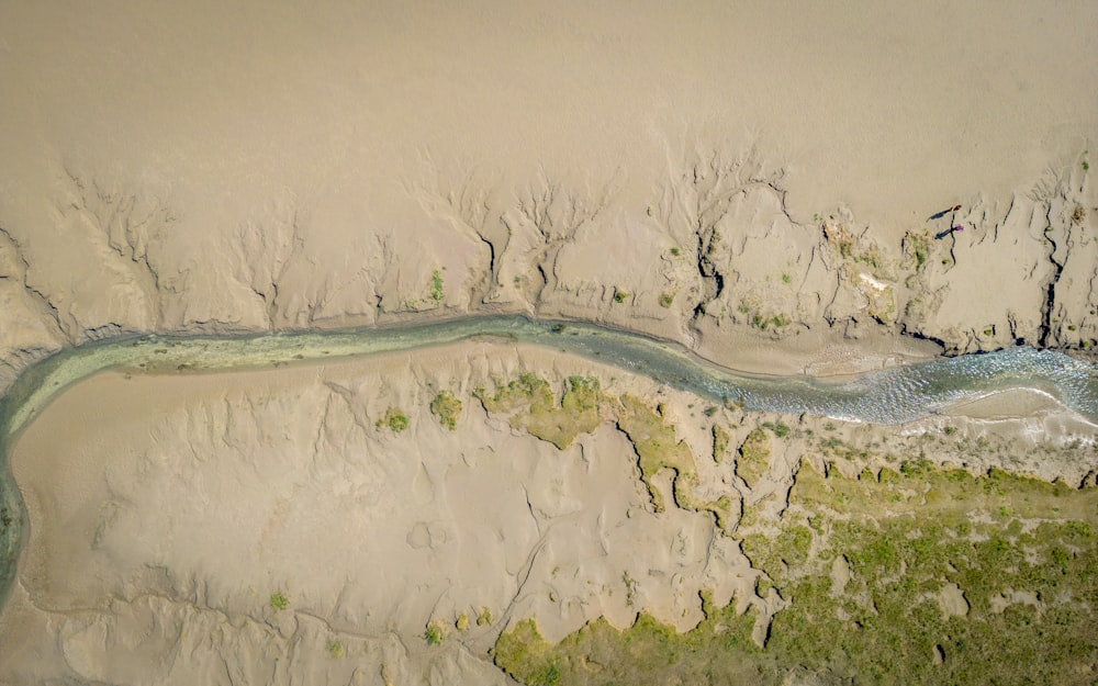 an aerial view of a river running through a desert