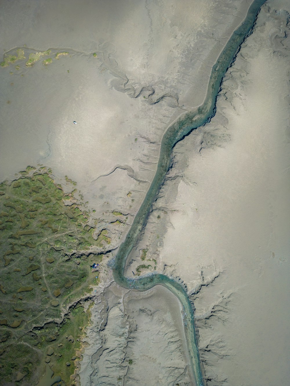 an aerial view of a river and land