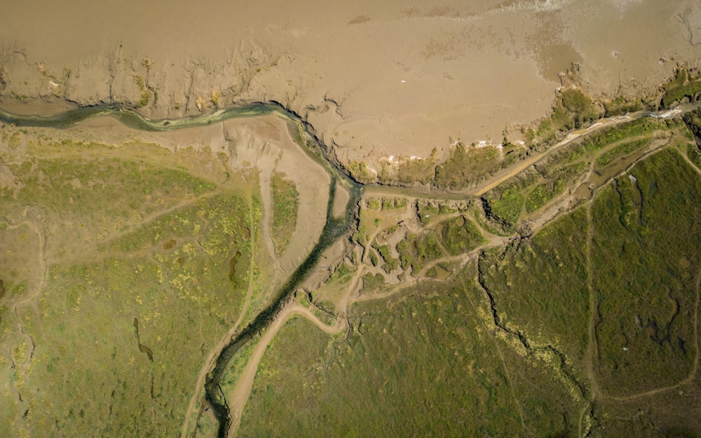 a river running through a lush green countryside