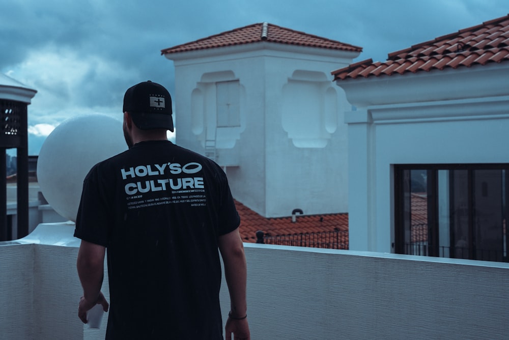 a man standing on a roof looking at the sky