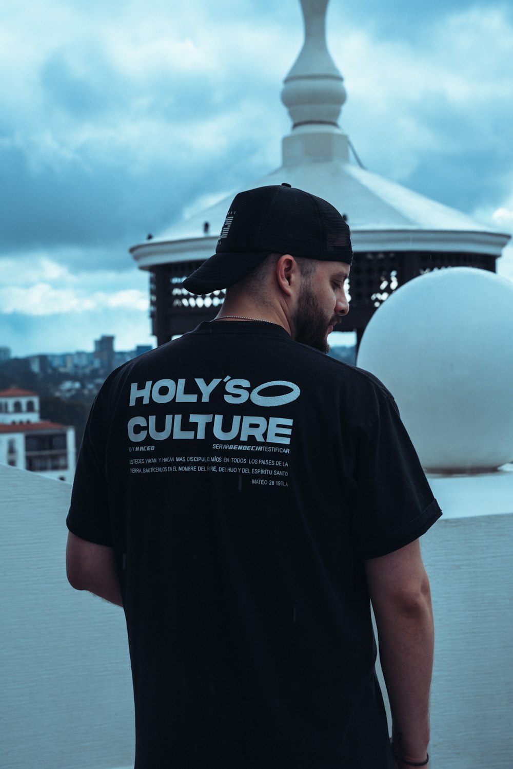 a man in a black shirt is standing on a roof