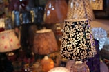 A collection of various lamps displayed on a wooden table.