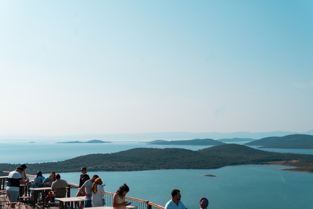 a group of people sitting at a table on top of a hill