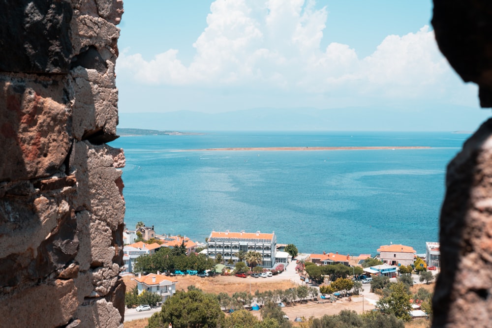 a view of a body of water from a stone wall