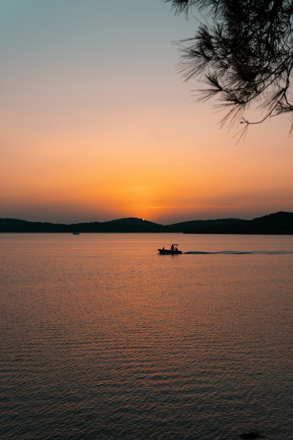 a boat is out on the water at sunset