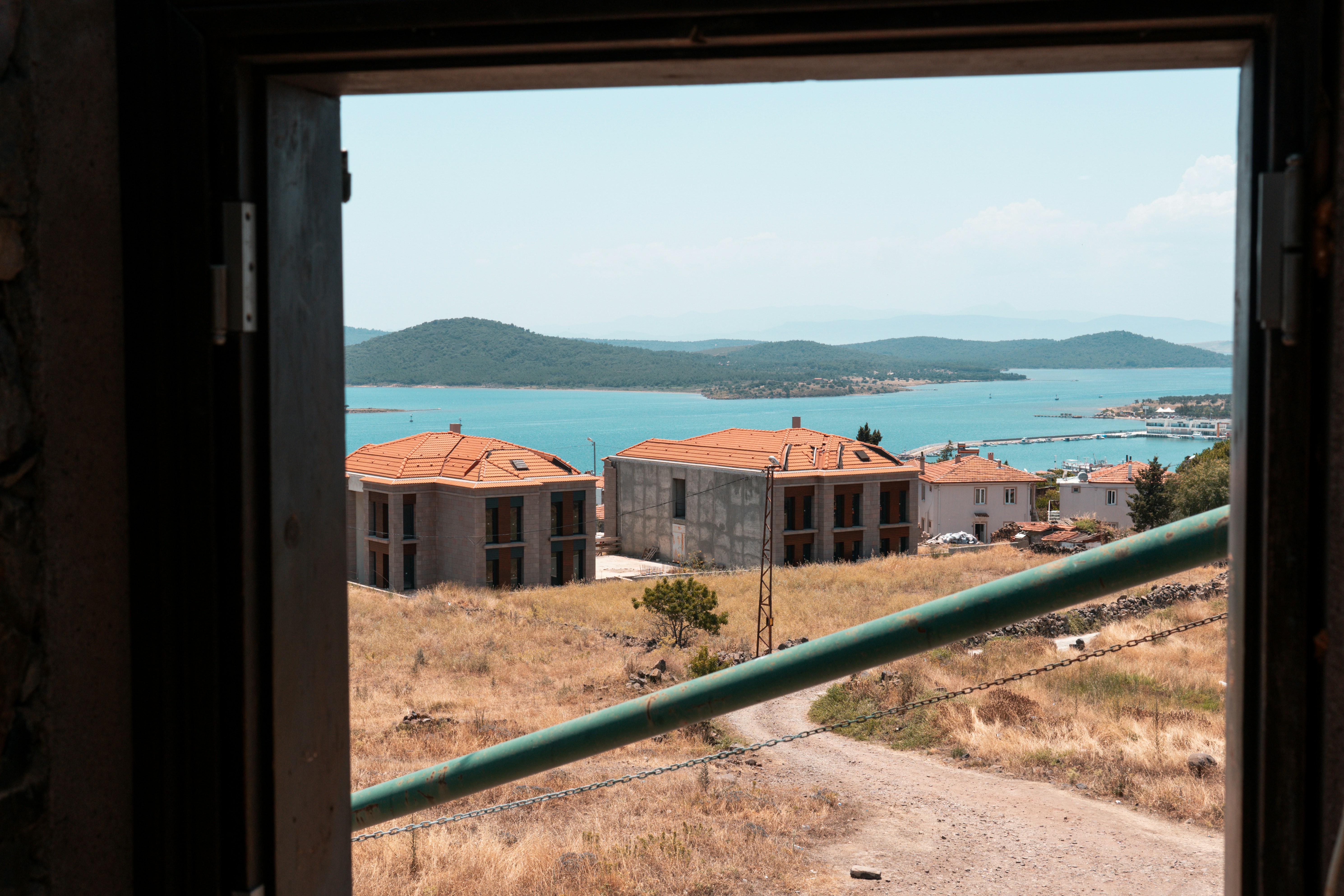 a view out of a window of a building and a body of water