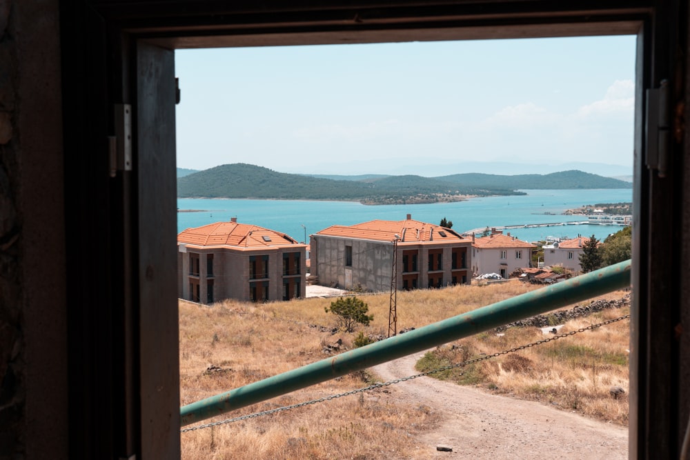 a view out of a window of a building and a body of water