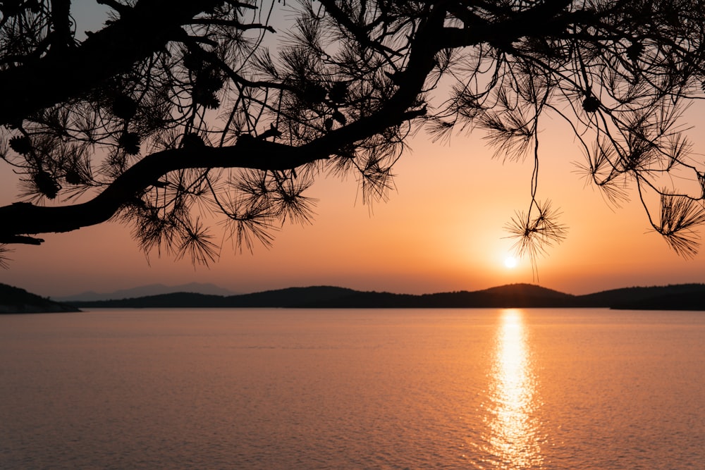 the sun is setting over a body of water