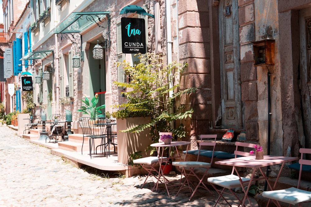 a row of tables and chairs outside of a building