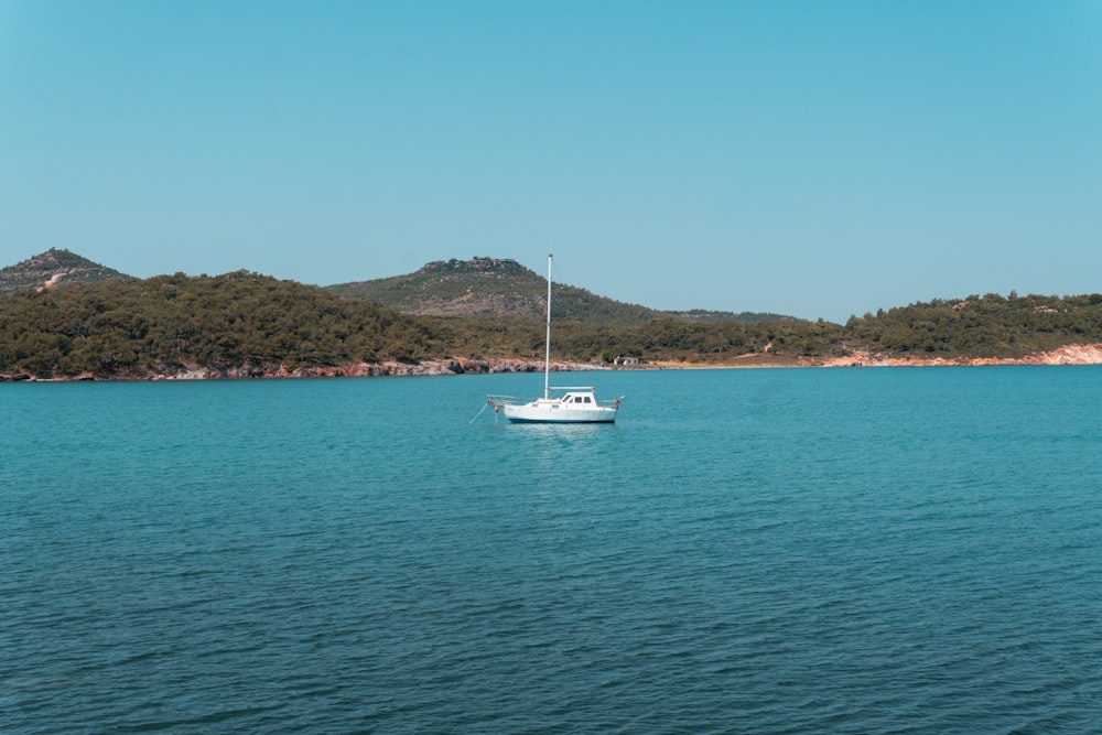 a sailboat floating on a large body of water