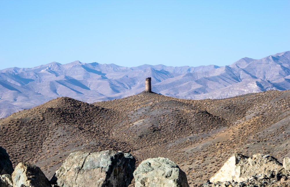 a mountain range with a tower in the middle