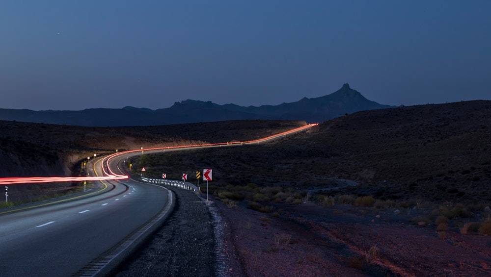 a long exposure shot of a highway at night