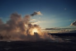 Sunset over Yellowstone Lake with steam rising from nearby hot springs.