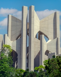 Modern architectural building blending with green surroundings under a clear sky.