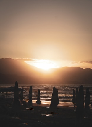 Sunset over a pristine beach in Tumbes with calm waters and golden sand.