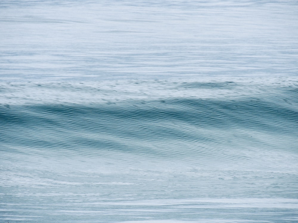 a man riding a wave on top of a surfboard