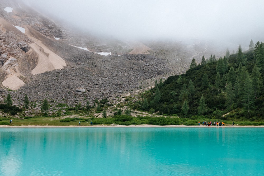 a body of water surrounded by mountains and trees