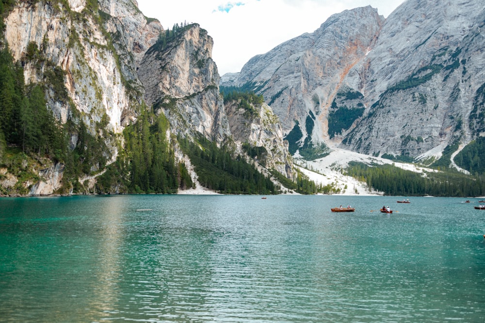 a group of boats floating on top of a lake