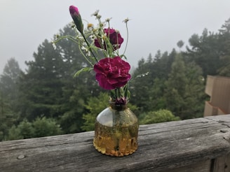 An elegant ceramic vase holding a small bouquet of wildflowers.