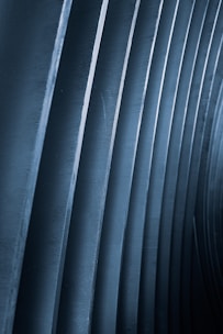 a black and white photo of a row of metal pipes