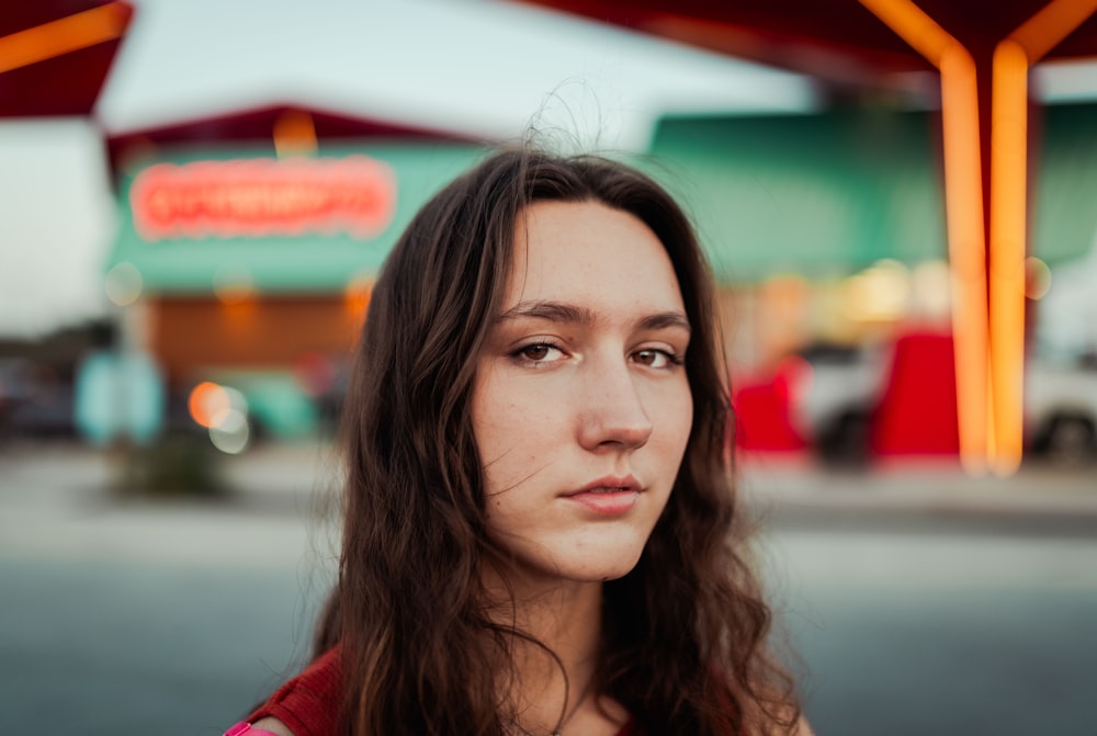 a woman standing in front of a gas station