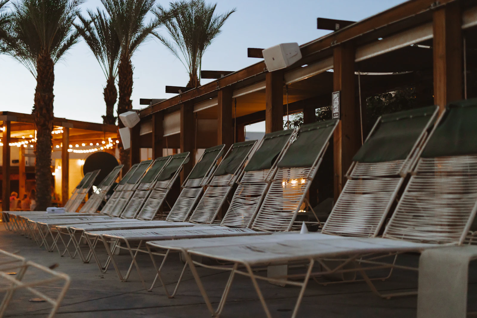 A row of lounge chairs beside a pool