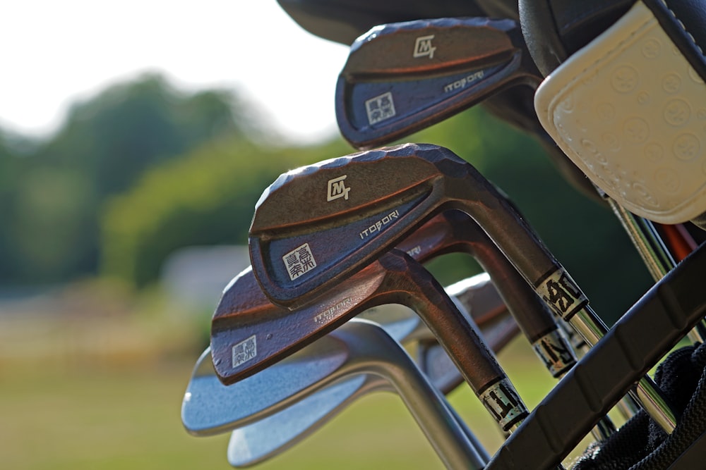 a close up of a set of golf clubs