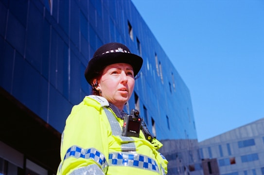 a woman police officer standing in front of a building