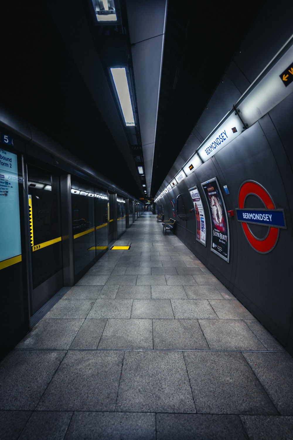 a subway station with a few people on the platform