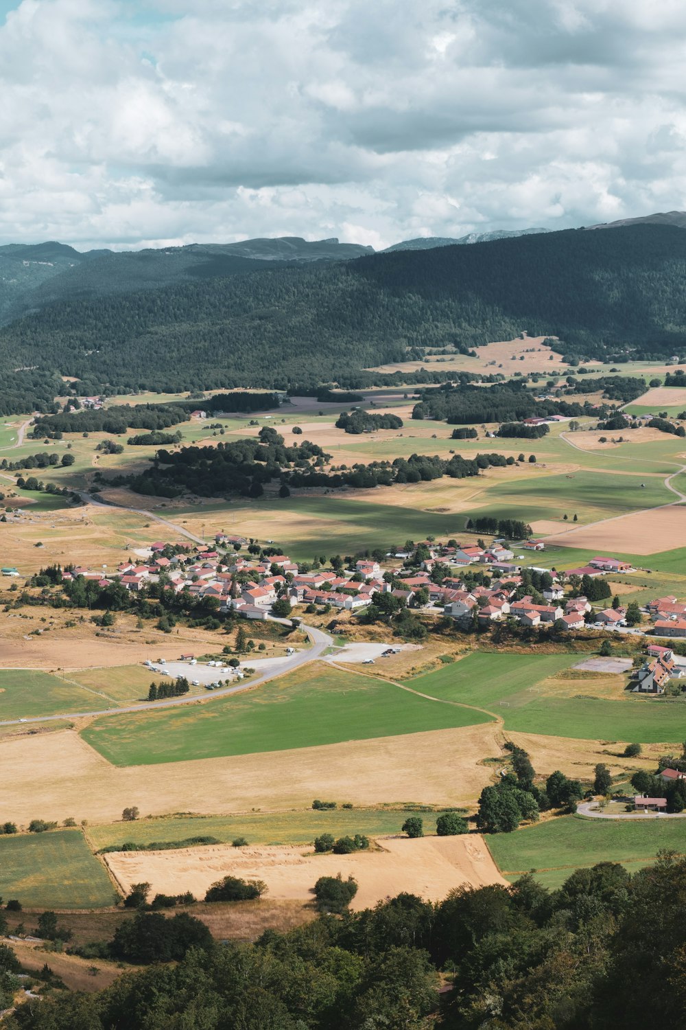 an aerial view of a small town surrounded by mountains