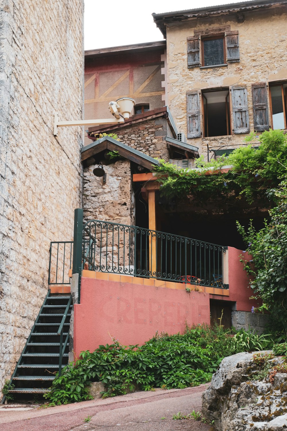 a stone building with a balcony and stairs