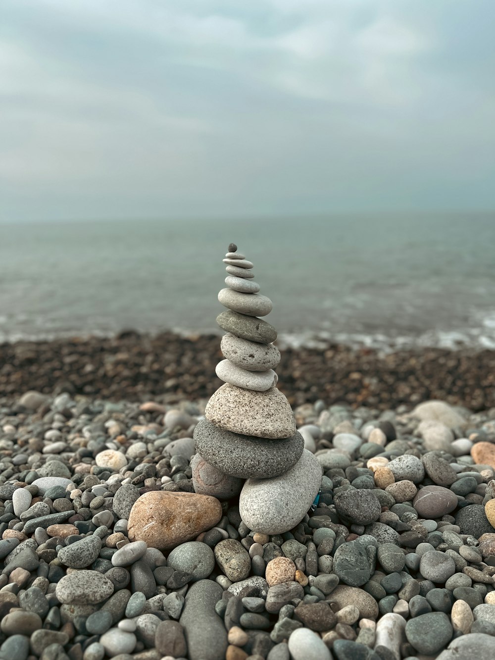 a stack of rocks sitting on top of a rocky beach