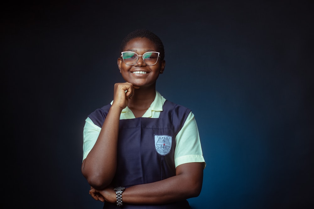 a woman wearing glasses and a blue apron