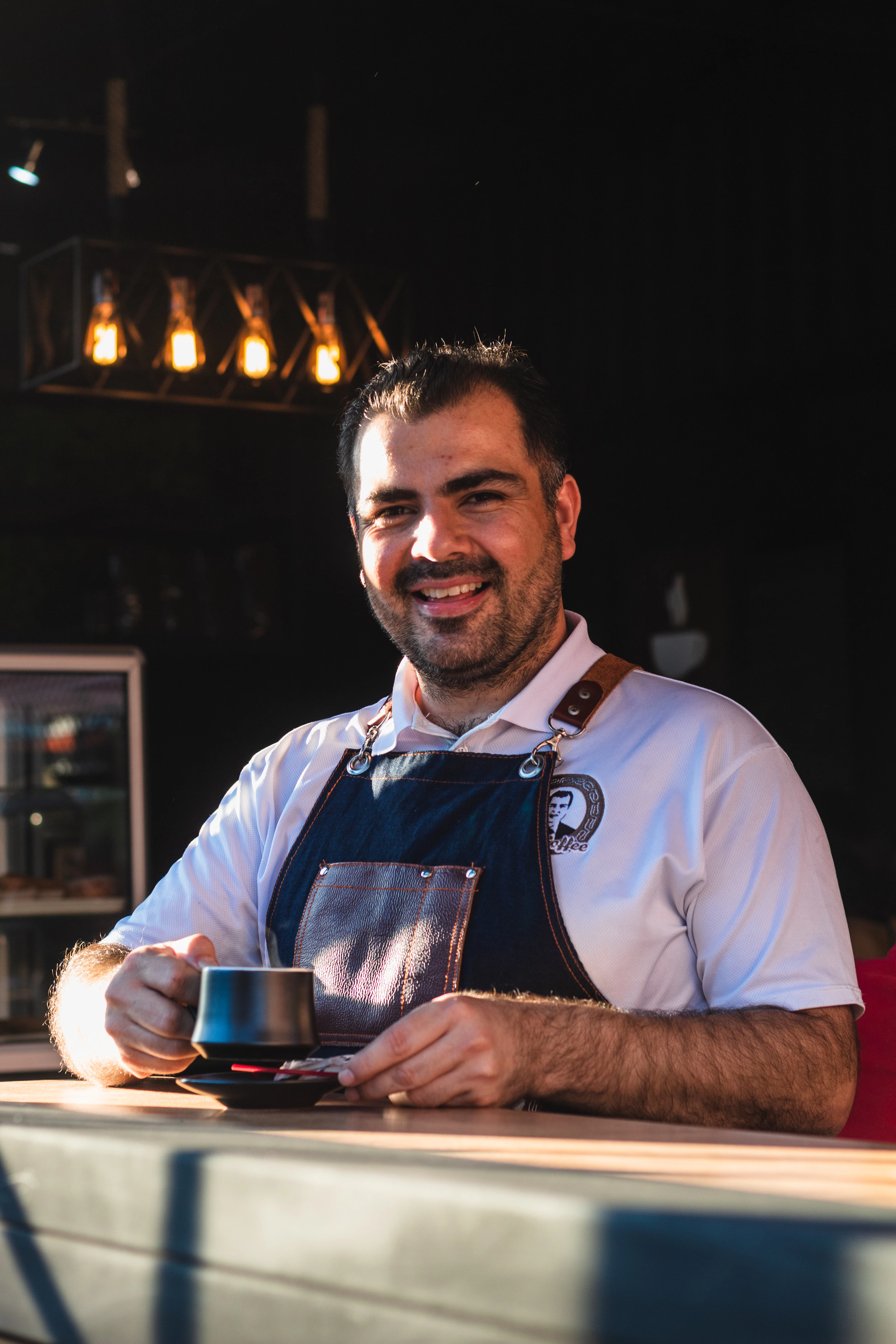 Marco Ruiz smiling at a café table