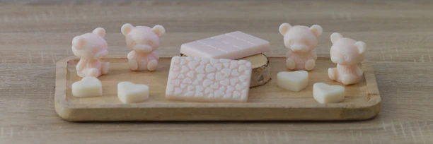 A cozy scene showing handmade candles and soaps arranged on a rustic wooden table.
